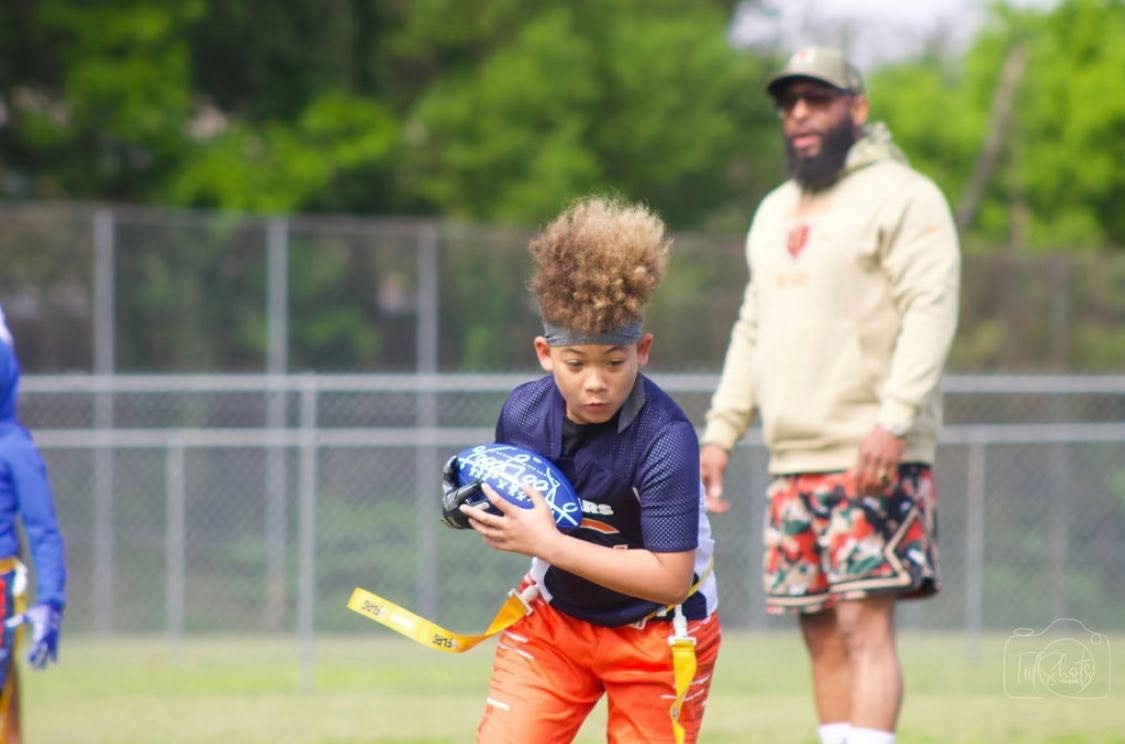 Youth player running with football — Jett Life YFF