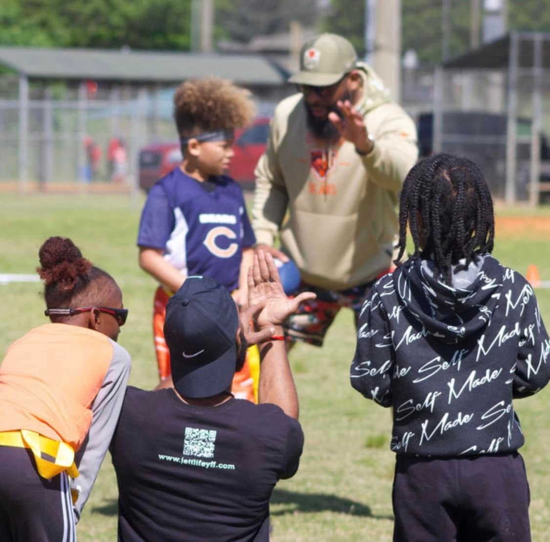 Jean-Paul Waterford in coaching huddle — jettlifeyff.com shirt visible