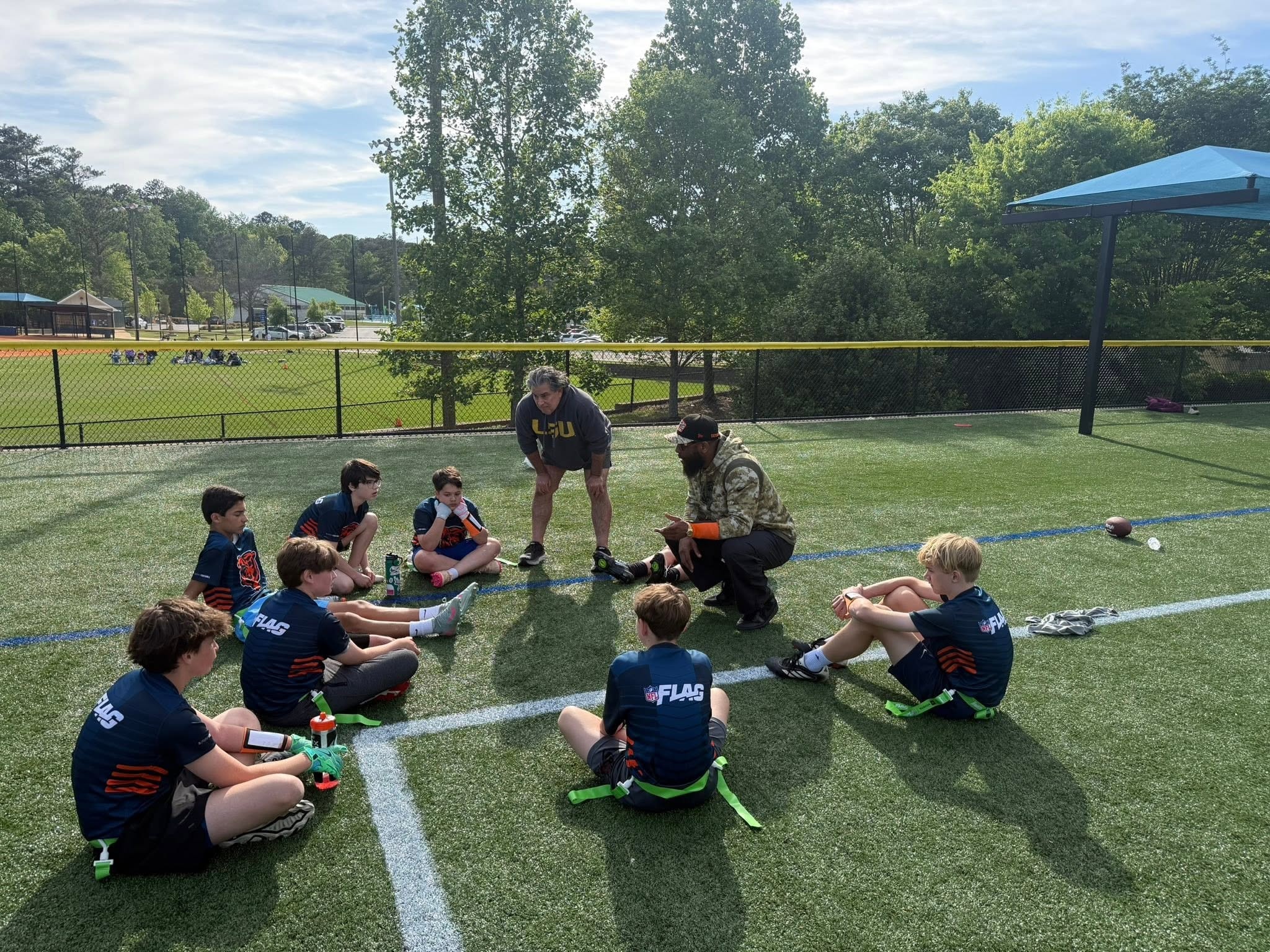 Jean-Paul Waterford coaching MJCC youth flag football team huddle